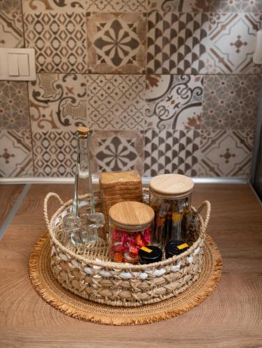 a basket with bottles and jars on a table at Amalia Luxury Room in Kalamaki Heraklion