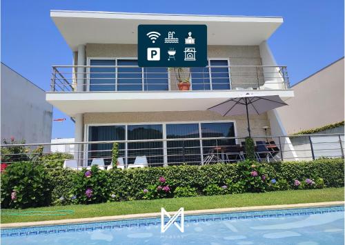 a building with a swimming pool in front of it at MyStay - Villa Luísa in Vila do Conde
