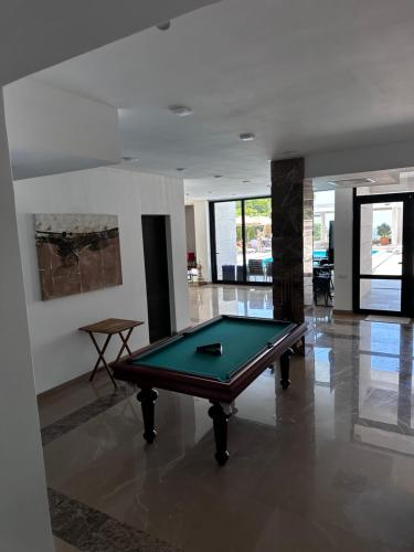 a pool table in the middle of a room at Villa Sunlight in Gonio