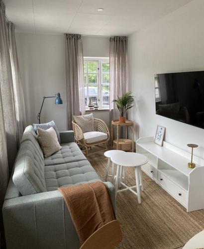 a living room with a couch and a table at Svalereden Strand Camping Apartments in Frederikshavn
