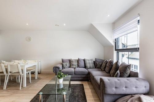 a living room with a couch and a table at Portrush Family Stay By The Beach 