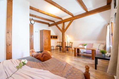 a room with a bed and a living room at Pension Marie in Český Krumlov