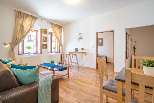 a living room with a couch and a table at Pension Marie in Český Krumlov