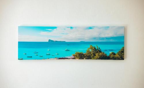 a picture of a beach with boats in the ocean at West Sand Holidays LICENSED BY THE TOURISM AUTHORITY 09926 in Flic-en-Flac