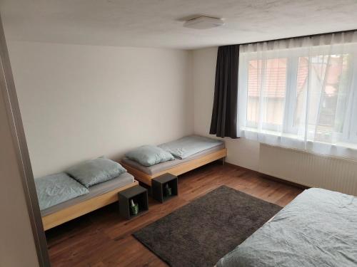 a bedroom with two beds and a window at Červená cesta in Kunovice