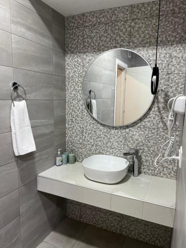 a bathroom with a sink and a mirror at Wellconect in Kutaisi
