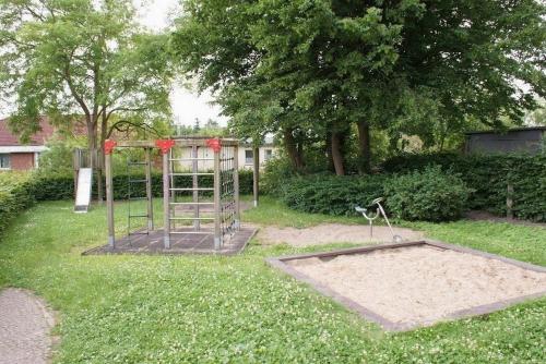 a playground in a yard with a trampoline at Ferienbungalow Klützer Winkel - ABC165 in Klütz