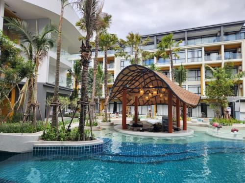 a swimming pool with a gazebo in front of a building at Wyndham Gardens Forrest View 1528 Studio in Nai Thon Beach