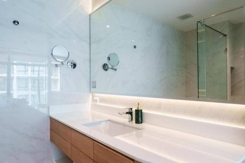 a bathroom with a sink and a mirror at Wyndham Gardens Forrest View 1528 Studio in Nai Thon Beach