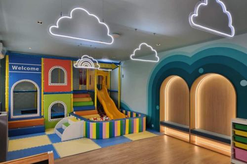a childrens play room with a slide and clouds at Wyndham Gardens Forrest View 1528 Studio in Nai Thon Beach