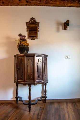 a wooden cabinet with a vase on top of a wall at Hiša Margarita in Ajdovščina