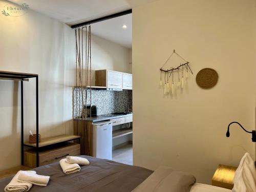 a room with a bed and a kitchen with a counter at elenasrooms in Kallithea Halkidikis