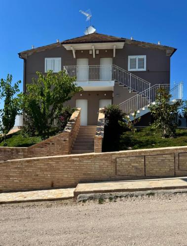 a large house with stairs in front of it at Mansio Murena in Petritoli