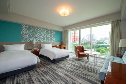 a hotel room with two beds and a large window at The Prince Park Tower Tokyo - Preferred Hotels & Resorts, LVX Collection in Tokyo