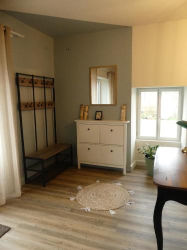 a room with a dresser and a mirror on the wall at Gite 15 personnes in LʼAbsie