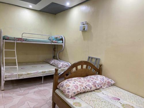 a room with two bunk beds in a room at Jp baybay view beach resort in Bolinao