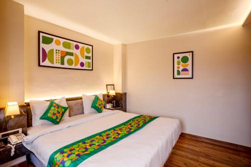 a bedroom with two beds with colorful pillows at Treebo Golden Leaf in Rānchī
