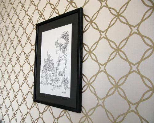 a framed drawing of a woman on a wall at Belle Apartments-Elegance Apartments in Belgrade