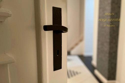 a wooden door with a black door knocker on it at FEWO-Hagemeister in Schwerin - ABC571 - keine Monteure in Schwerin