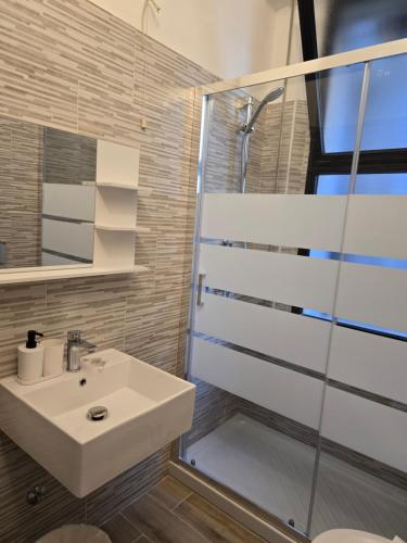 a bathroom with a sink and a shower at Hotel Annarita-mezza pensione plus- spiaggia inclusa in Rimini