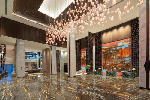 a lobby with a large chandelier in a building at Crowne Plaza Putian by IHG in Putian