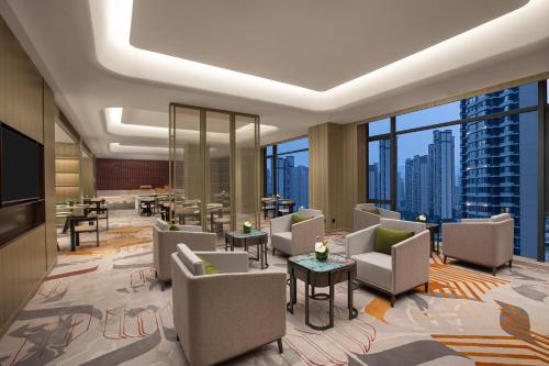 a hotel lobby with chairs and tables and windows at Crowne Plaza Putian by IHG in Putian