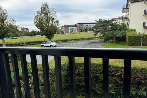 a car driving down a street from a balcony at Modern apartment with direct beach access in Cabourg