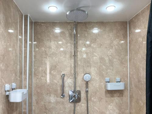 a bathroom with a shower and a sink at Thistle Dubh in Drumnadrochit