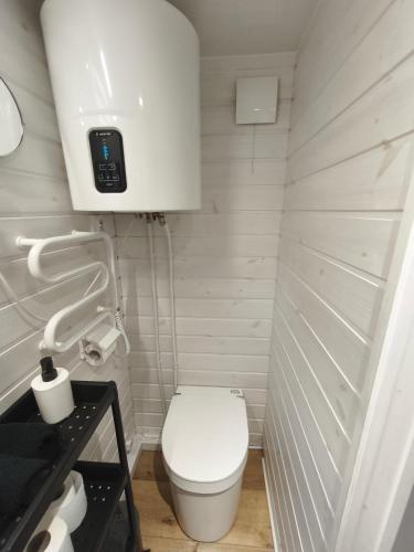 a small bathroom with a toilet and a sink at City TinyHouse under WaterTower in Wrocław