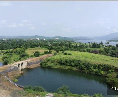 an aerial view of a river with a bridge at Kalyan luxury rooms in Garudeshwar
