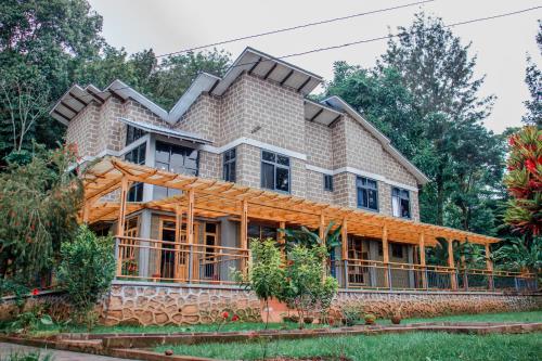 a house with a roof on top of it at Avocado Kilimanjaro Homes in Marangu