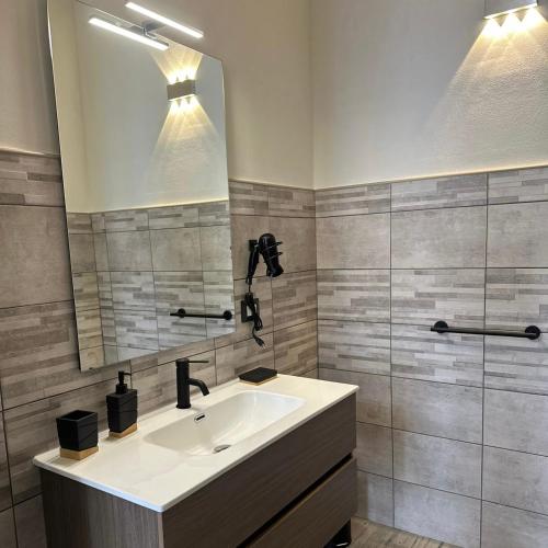a bathroom with a sink and a mirror at B&B Magiulsà in Siniscola