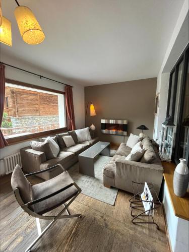 a living room with a couch and a table at Hotel Ermitage Verbier in Verbier