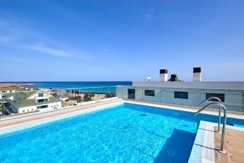 a swimming pool with a view of the ocean at Apartamento Praia Santa Maria in Santa Maria