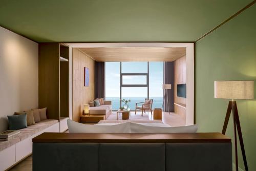 a living room with a large white tub in a room at Signature by M Village Beachfront Hotel in Da Nang