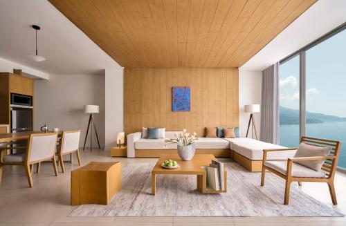 a living room with a couch and a table at Signature by M Village Beachfront Hotel in Da Nang