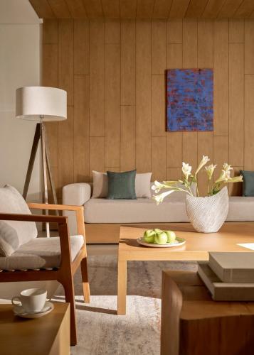 a living room with a couch and a table at Signature by M Village Beachfront Hotel in Da Nang