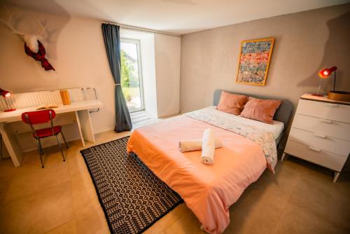 a bedroom with a bed with two towels on it at Villa en plein cœur de Leysin in Leysin