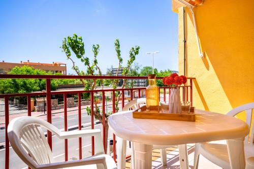a white table and chairs on a balcony at ED. MISTRAL VIDABER in Oropesa del Mar