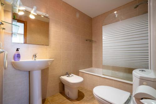 a bathroom with a sink and a toilet and a tub at Colomeras Vidaber in Oropesa del Mar