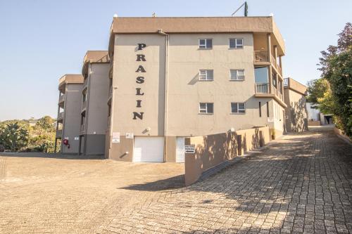 a building with a sign on the side of it at Praslin 4 in Margate