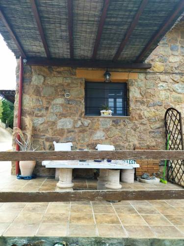 a stone building with a stone table in front of it at STONEHOUSE & CASA AL SOLE e AL MARE in Nea Roda