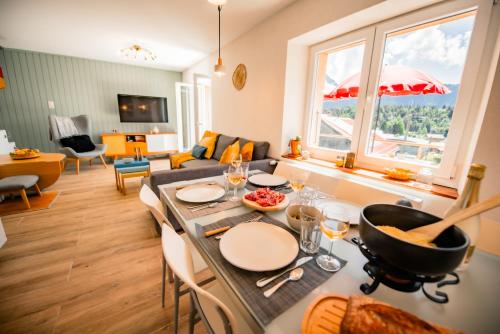 a kitchen and living room with a table and chairs at Villa en plein cœur de Leysin in Leysin