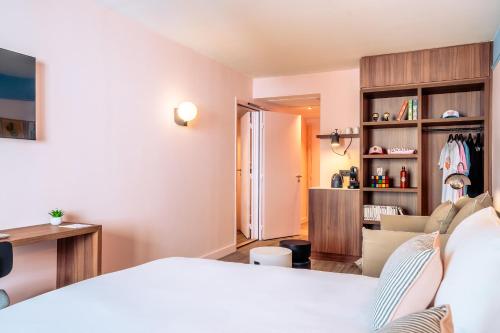 a bedroom with a bed and a living room at RockyPop Marseille Hôtel in Marseille