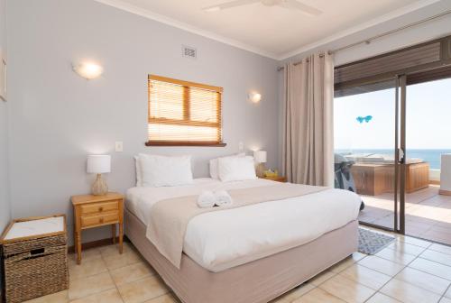 a bedroom with a bed with a view of the ocean at Chaka Terraces 10 in Ballito