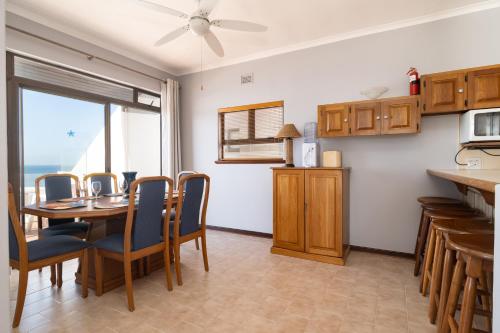 a kitchen and dining room with a table and chairs at Chaka Terraces 10 in Ballito