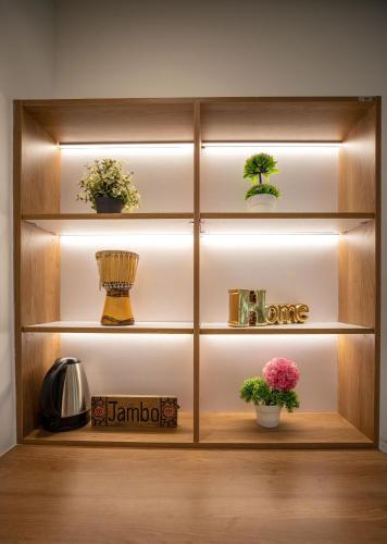 a book shelf with potted plants and lights at Gigiri Lion Villas I in Nairobi