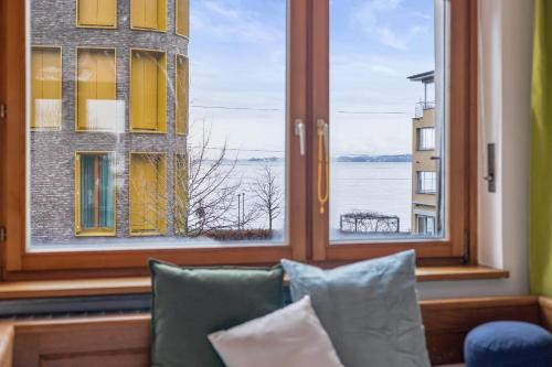 a room with a couch and a window with a view at Villa Seeblick 1908 in Bregenz