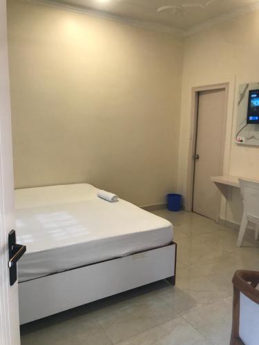 a bedroom with a bed and a tv on the wall at shangrila stay in Bodh Gaya