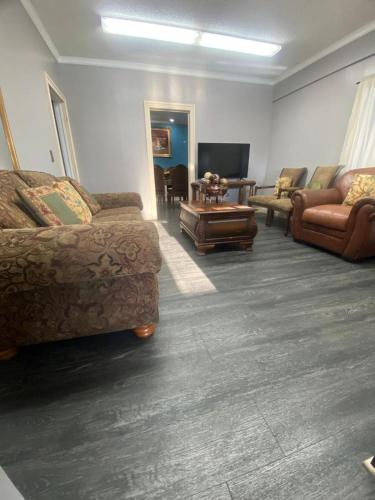 a living room with two couches and a table at Best value 3 Huge Bedrooms-Multiple parkings in Willmar